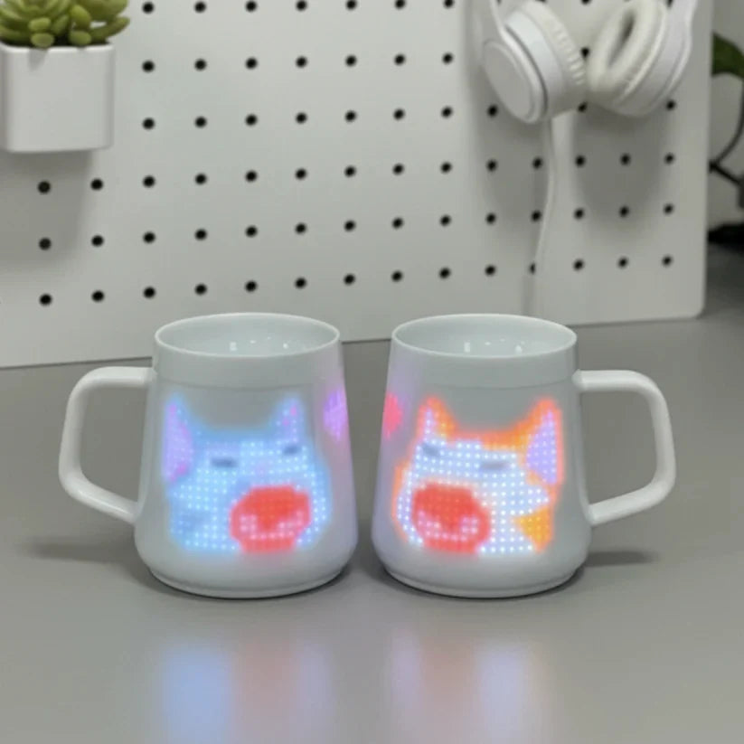 Two mugs displaying colorful pixel characters